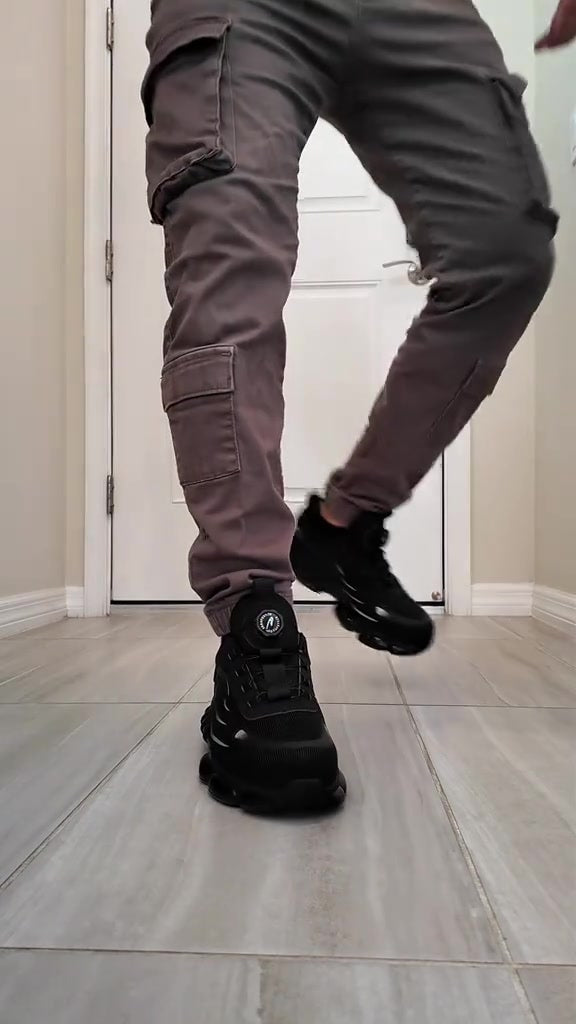 Walking toward the camera in SteelTurn safety sneakers through a doorway